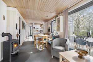 a tiny house with a wood stove in a living room at 6718-Hasle-Baga-8 in Hasle