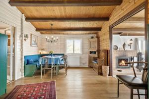 a dining room with a table and chairs and a fireplace at 6685-Allinge-Tejnvej-24 in Allinge