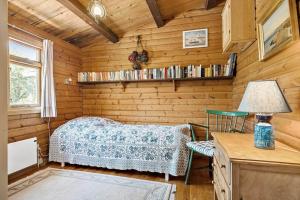 a room with a bed and a table and a lamp at 6685-Allinge-Tejnvej-24 in Allinge