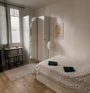 a bedroom with a bed and a table and a window at Stylish and cozy apartment in central Nice in Nice