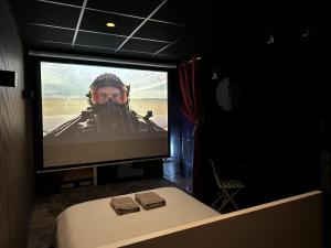 a television screen with a man on a battlefield at Cocon Jacuzzi et cinéma 4K B in Bordeaux