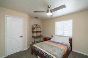 a bedroom with a bed and a ceiling fan at Havasu Oasis Games for Kids BBQ Boat Parking in Lake Havasu City