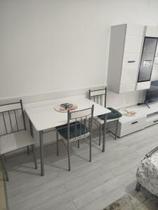 a dining room with a white table and chairs at Vea in Banja Koviljača