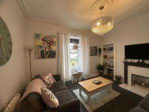 a living room with a couch and a table at Wellington Retreat in Montrose