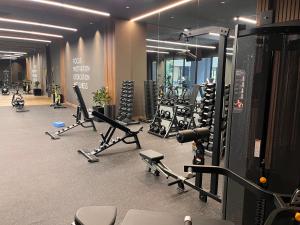 a gym with a bunch of treadmills and machines at Luxury High-Floor 3 Bedroom Apartment FREE Pool & Gym in Guatemala