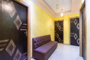 a waiting room with a purple couch in a hallway at Hotel O Holiday in Tangra +30 photos