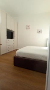 a bedroom with a bed and a flat screen tv at Reverie in Foligno