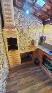 a pizza oven in a room with a brick wall at Casa de temporada do Mr Bim in Cabo Frio