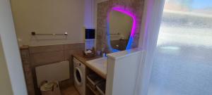 a bathroom with a sink and a mirror at Le Mulaty Cozy in Tossiat