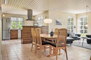 a kitchen and dining room with a table and chairs at LF584-Hurup-Thy-Haettemagevej-4 in Sindrup