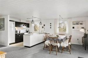 a kitchen and dining room with a table and chairs at LF593-Vestervig-Ingeborgs-Alle-21 in Vestervig