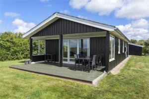 a black cabin with a table on a deck at LF593-Vestervig-Ingeborgs-Alle-21 in Vestervig