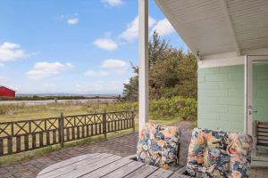 un portico con due sedie e una recinzione di LF16234-Logstor-Gerdasvej-6 a Løgsted