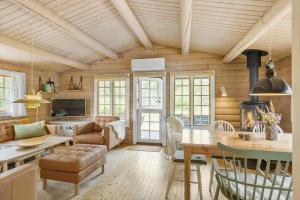 a living room with a table and a dining room at 1444-Aakirkeby-Poseregardsvejen-15 in Vester Sømarken