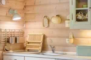 a kitchen with a sink and a wooden wall at 1444-Aakirkeby-Poseregardsvejen-15 in Vester Sømarken +13 photos