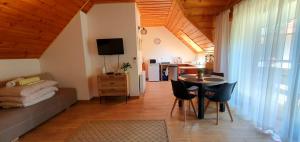 a small living room with a table and a couch at Pokoje "na Pierniku" in Szczawnica