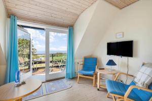 a living room with a view of a patio at 5613-Allinge-Bohnebakken-21-Lejl-1 in Allinge