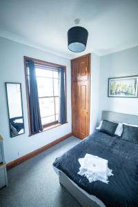 a bedroom with a large bed and a window at One BR Flat By Eason Stays Short Lets & Serviced Accommodation Lowestoft With Free Parking in Lowestoft