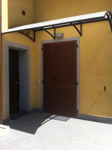 a garage with a brown door and a building at C'era Una Volta in Bastia Umbra