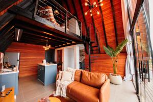a living room with a couch and a loft at Chalé com hidro e vista! in Imaruí