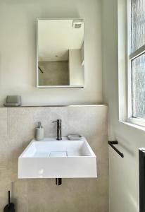 a white sink in a bathroom with a mirror at Luxury 2 bedroom flat Gleneagles in Moffat