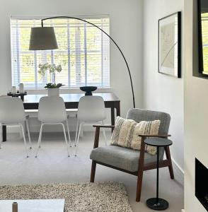 a living room with a table and chairs and a lamp at Luxury 2 bedroom flat Gleneagles in Moffat