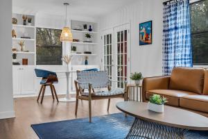 a living room with a couch and a table at Modern King Bed 5 mins to Downtown in Tulsa