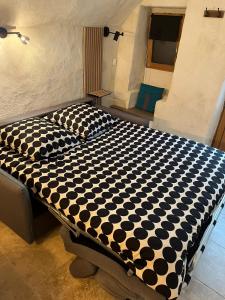 a black and white bed in a room at Studio cosy in Bourg-Saint-Andéol