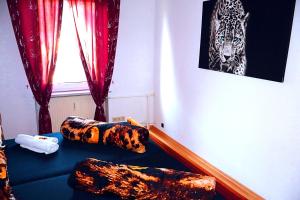 a room with a blue couch with animal print pillows at Holiday Rhein 4 in Boppard