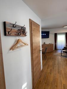 a room with a door and a living room at Liesingtal Deluxe Balcony Suite in Liesingthal