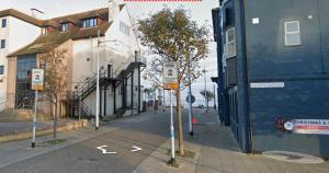 an empty street with street signs on the side of a building at One BR Flat By Eason Stays Short Lets & Serviced Accommodation Lowestoft With Free Parking in Lowestoft