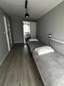 a room with two beds in it with a window at Apartament nad Nysą Kłodzką in Kłodzko