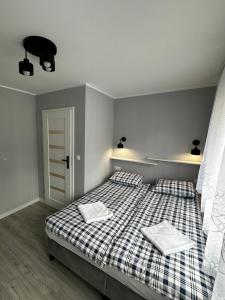 a bedroom with a bed with two pillows on it at Apartament nad Nysą Kłodzką in Kłodzko