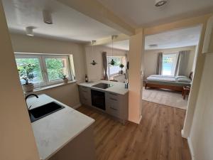 a kitchen with a sink and a counter top at Terrassenwohnung im Alstertal in Hamburg