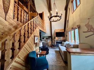 a living room with a staircase in a house at Rocky Pines UP in Bessemer