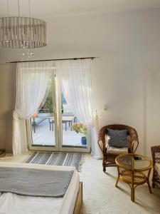 a bedroom with a bed and a chair and a window at Starosądecki zakątek in Stary Sącz