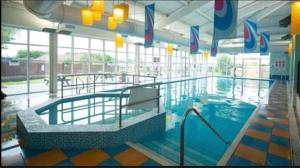 a large swimming pool in a large building at Withernsea sands-Maple grove in Waxholme