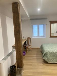 a bedroom with a bed and a desk and a window at Studio&Rooms Ortuzar in Durango