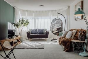 a living room with a couch and a chair at Hokitika Beach Break in Hokitika