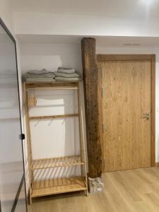 a room with a closet with a wooden door at Studio&Rooms Ortuzar in Durango +59 photos