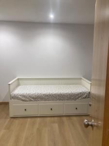 a bed sitting in a room next to a door at Studio&Rooms Ortuzar in Durango