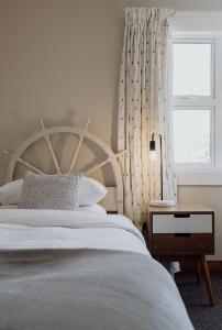 a bedroom with a large bed and a window at Hokitika Beach Break in Hokitika