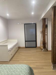 a bedroom with a bed and a projection screen at Studio&Rooms Ortuzar in Durango