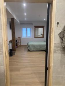 a view of a bedroom with a bed and a mirror at Studio&Rooms Ortuzar in Durango +58 photos