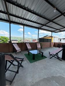 a patio with two chairs and a table on a roof at casa del sol in Tena