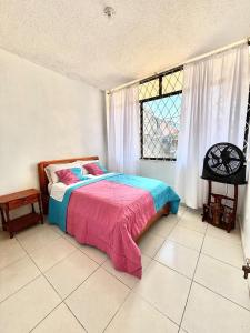 a bedroom with a bed and a window at casa del sol in Tena