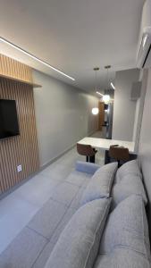 a bedroom with a bed and a dining table at Flat magnífico bairro nobre in Imperatriz