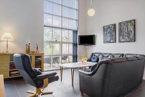 a living room with a couch and a table at LF14211-Roslev-Vile-Vestergardvej-34-Lejl-A-tv in Roslev