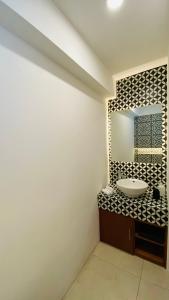 a bathroom with a sink and a mirror at Casa Sierra Negra in Hacienda Blanca +1 photo