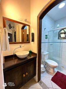 a bathroom with a sink and a toilet and a shower at Casa Naturaleza in Ilhabela +70 photos